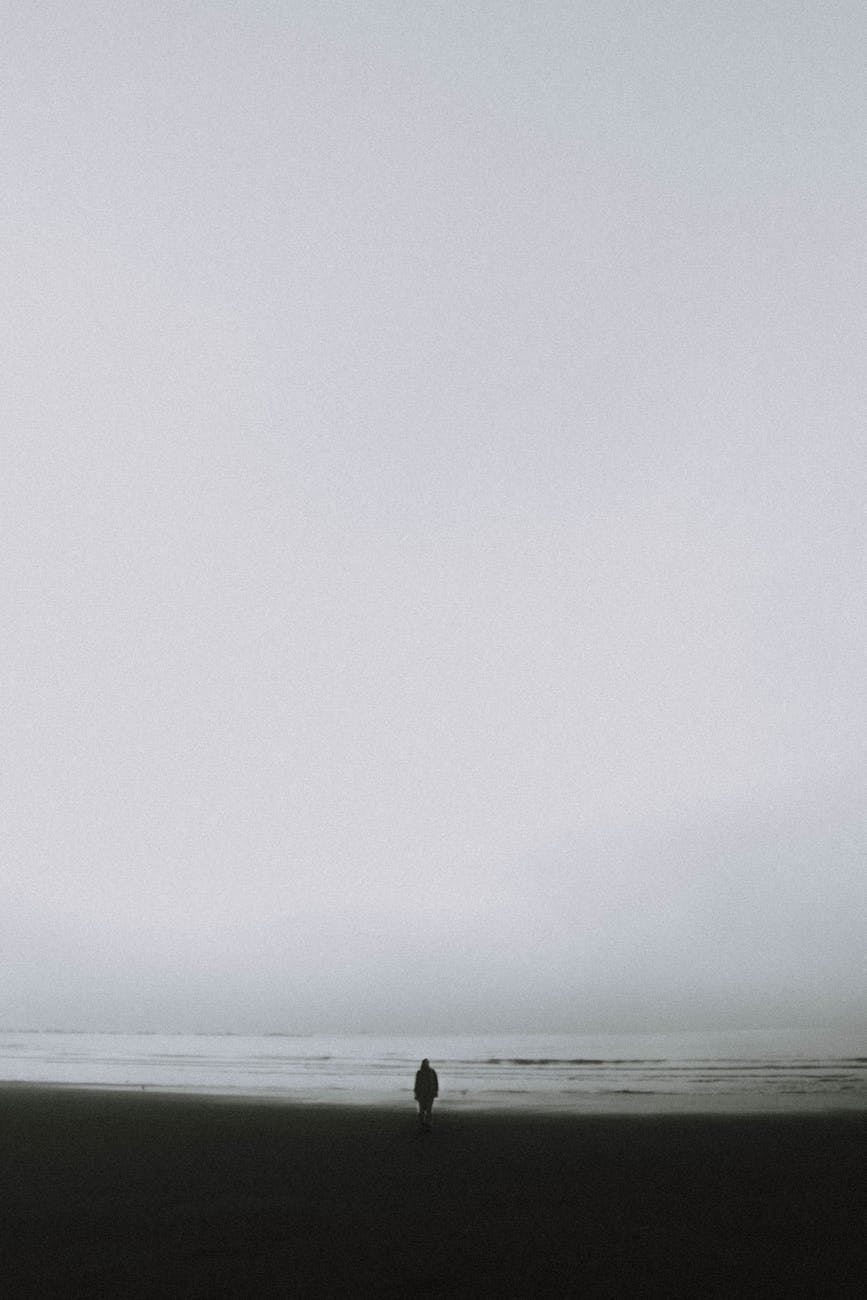 lonely person standing on seashore