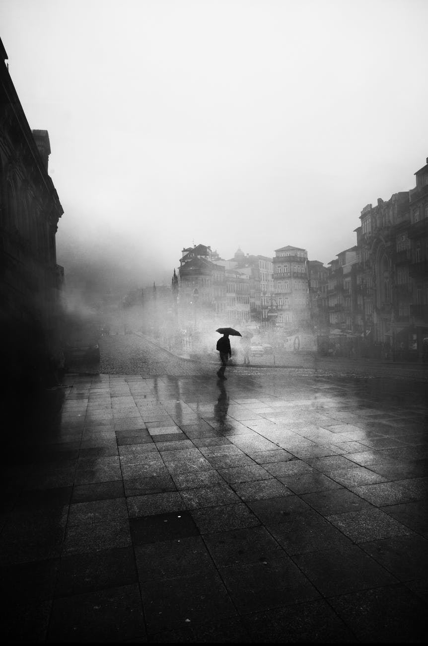 black and white photo of man with umbrella